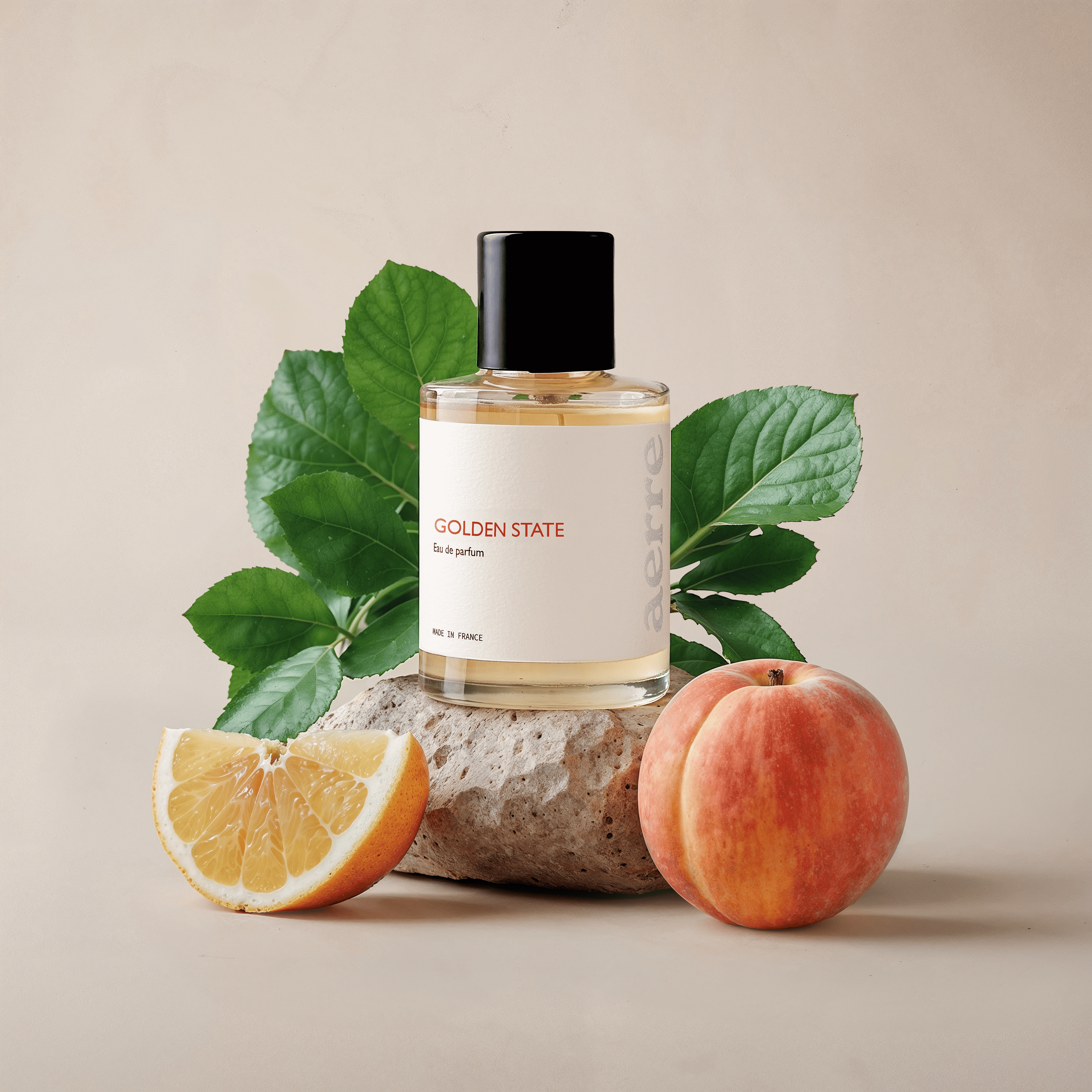 Aerre perfume bottle labeled 'Golden State' with a peach, orange and green leaves on a beige background