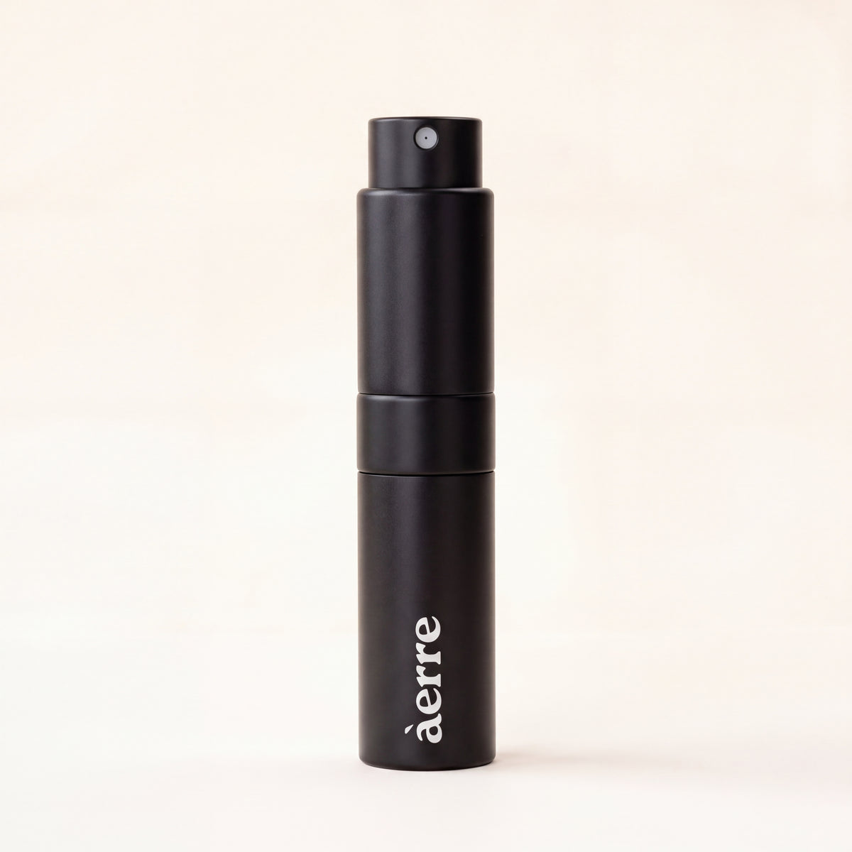 A matte black perfume atomiser with the brand name 'aerre' printed in white near the bottom, set against a solid off-white background.