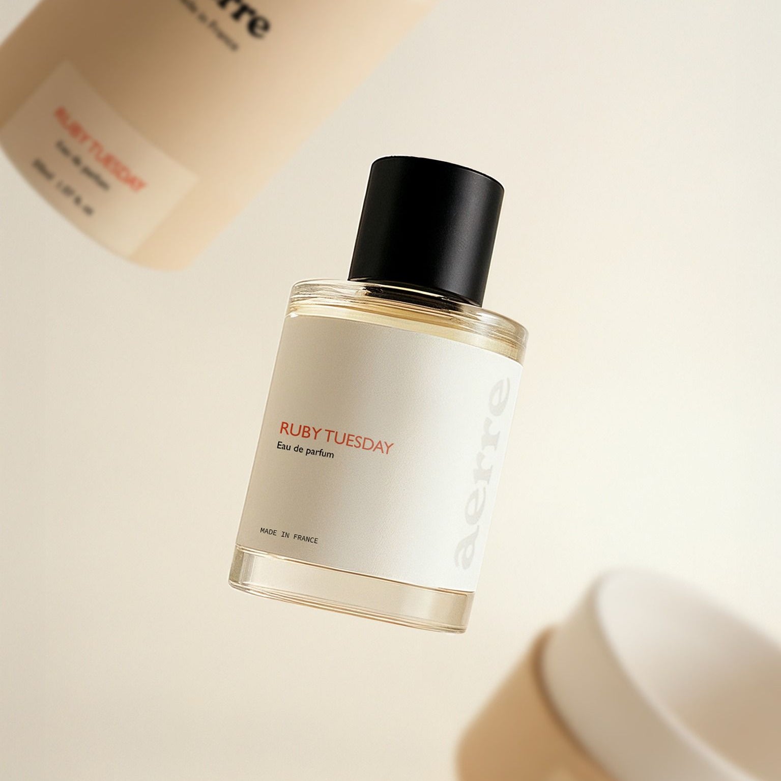 Aerre Perfume bottle labeled 'Ruby Tuesday' floating against a light background